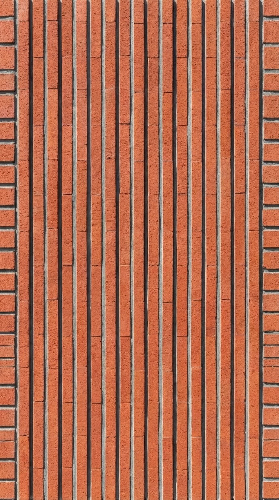 Fachada con ladrillo cara vista colocado en posición vertical en lugar de horizontal